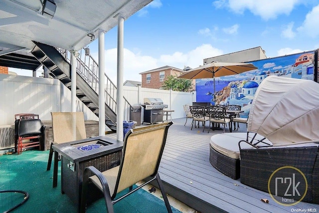 deck featuring area for grilling and an outdoor fire pit