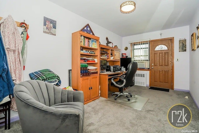 office space with radiator heating unit and light carpet