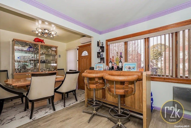 bar with hardwood / wood-style flooring, ornamental molding, and a wall unit AC