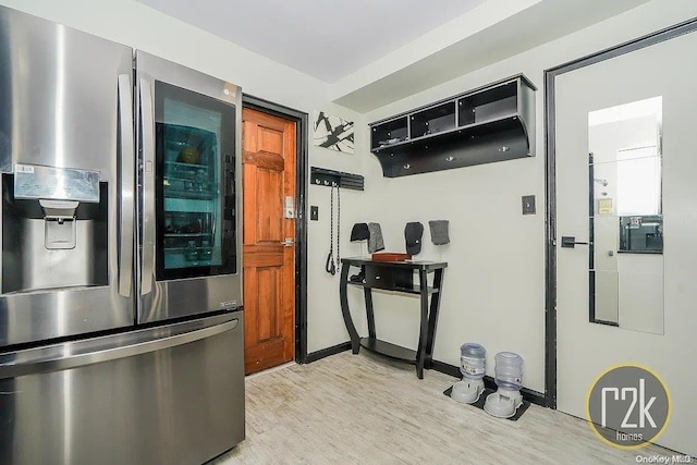 kitchen with stainless steel fridge and light hardwood / wood-style floors