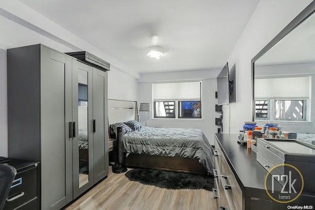 bedroom featuring light wood-type flooring and multiple windows