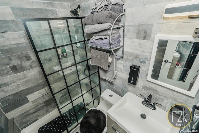 bathroom with a shower, sink, and tile walls