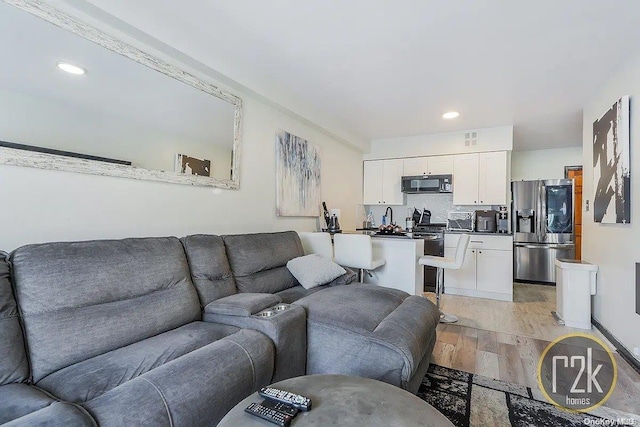 living room with light hardwood / wood-style floors