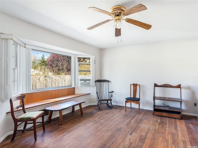 sitting room with dark hardwood / wood-style flooring, ceiling fan, and cooling unit