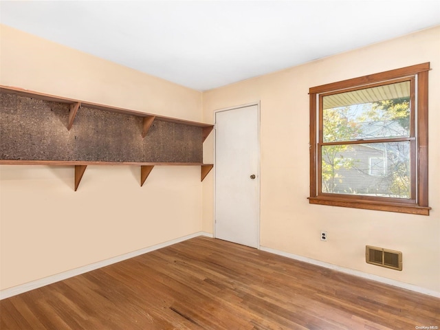 unfurnished room featuring wood-type flooring