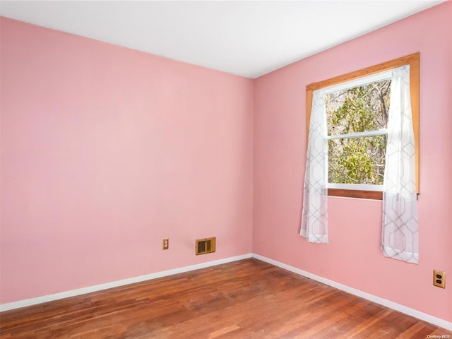 unfurnished room with wood-type flooring