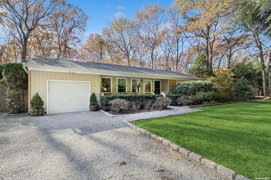 single story home with a front yard and a garage