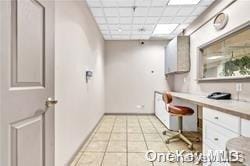 kitchen featuring a drop ceiling and light tile patterned floors