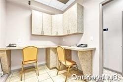 kitchen with white cabinets and light tile patterned floors