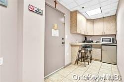 kitchen featuring a paneled ceiling and light tile patterned flooring