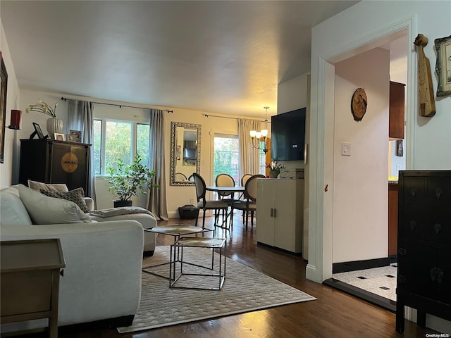 living room featuring dark wood-type flooring and a chandelier