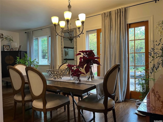 dining space with a chandelier, wood-type flooring, and a wealth of natural light