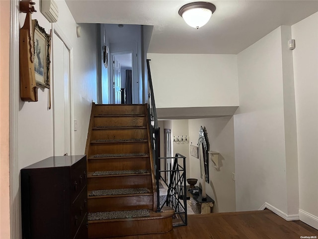 staircase featuring hardwood / wood-style flooring