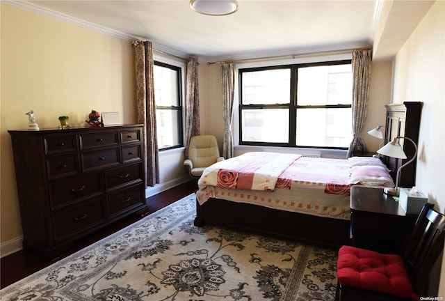 bedroom with crown molding and dark hardwood / wood-style flooring