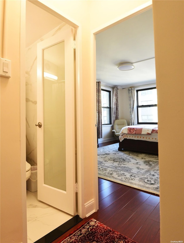 interior space featuring hardwood / wood-style floors and connected bathroom