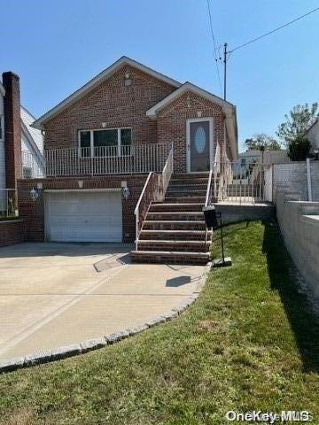 view of front facade with a front yard and a garage