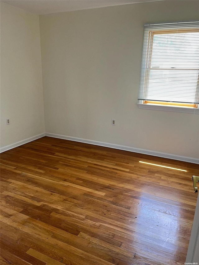 empty room featuring dark hardwood / wood-style flooring