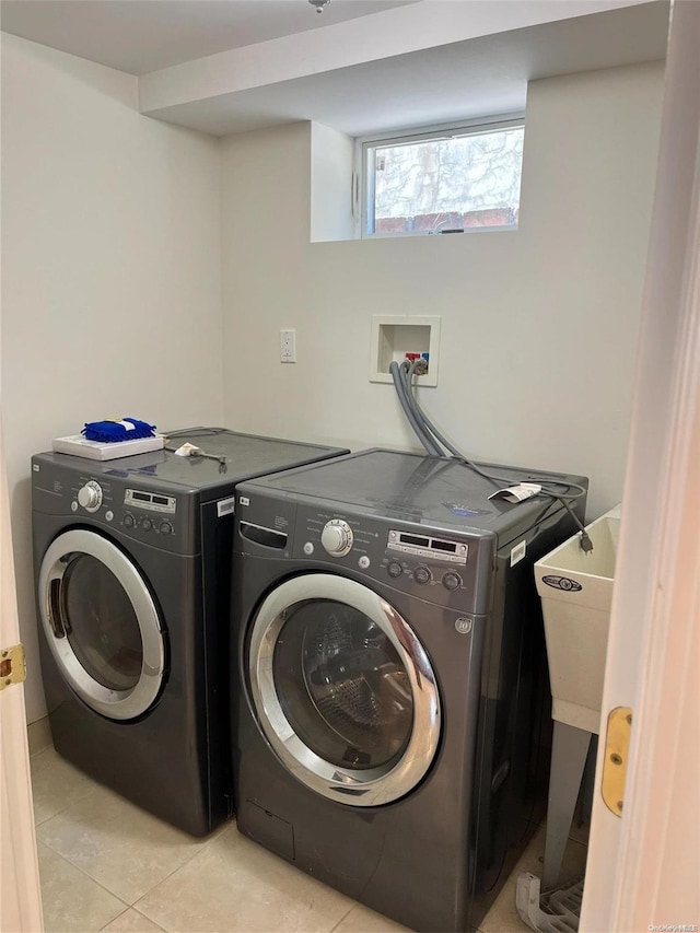 laundry room with light tile patterned floors and separate washer and dryer