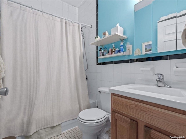 full bathroom with vanity, tile patterned floors, toilet, shower / bath combo with shower curtain, and tile walls