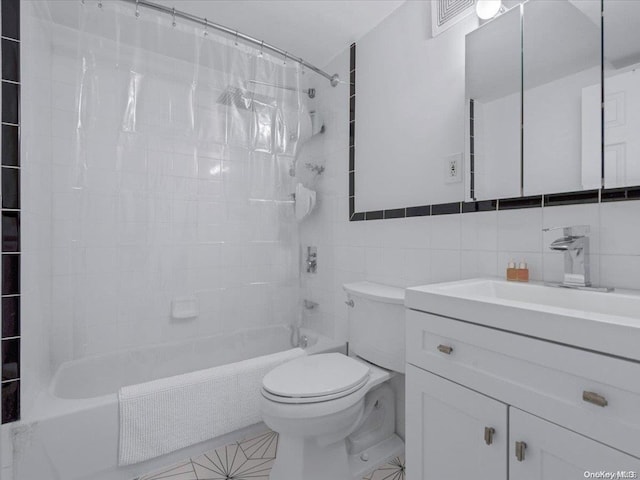 full bathroom with tile patterned flooring, tile walls, toilet, vanity, and shower / tub combo