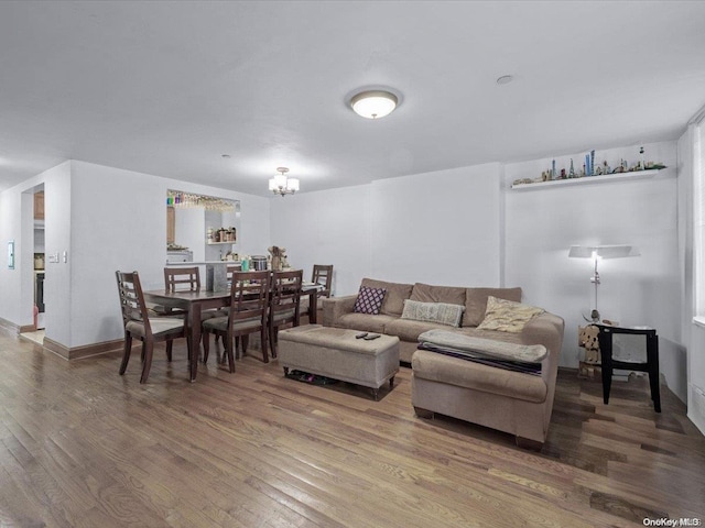 living room with hardwood / wood-style floors and an inviting chandelier