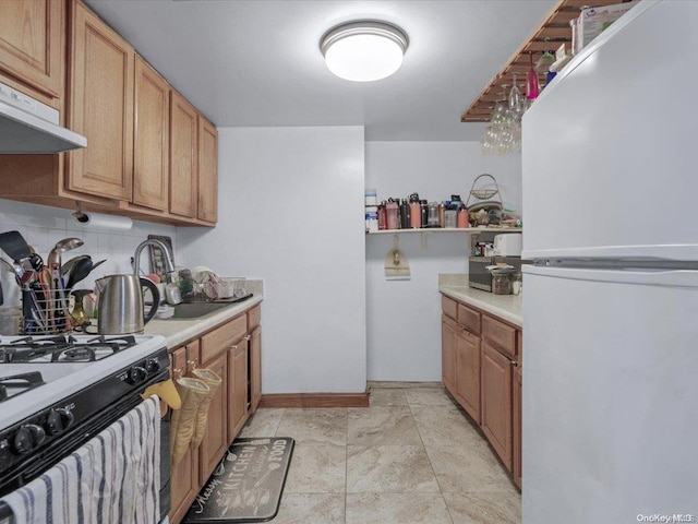 kitchen with sink, white appliances, and backsplash