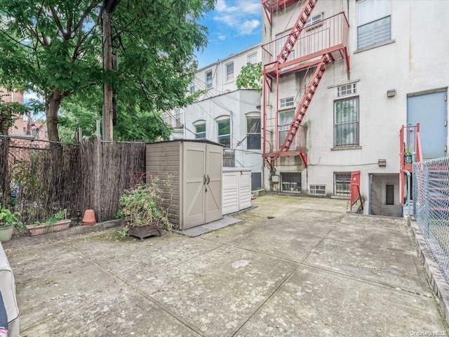 view of patio featuring a storage unit