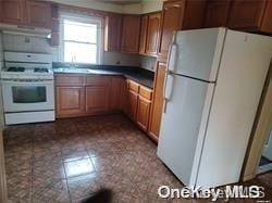 kitchen with white appliances and exhaust hood