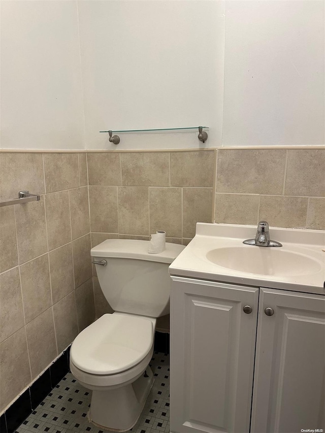 bathroom featuring tile walls, vanity, and tile patterned flooring