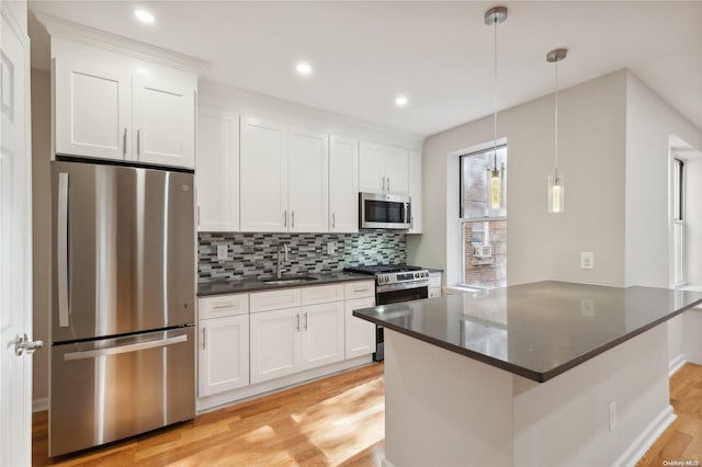 kitchen with sink, white cabinetry, and stainless steel appliances