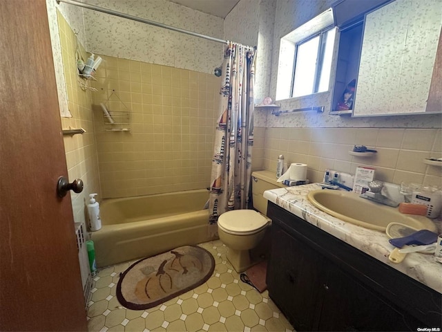 full bathroom featuring shower / bath combo, vanity, tile walls, tile patterned flooring, and toilet