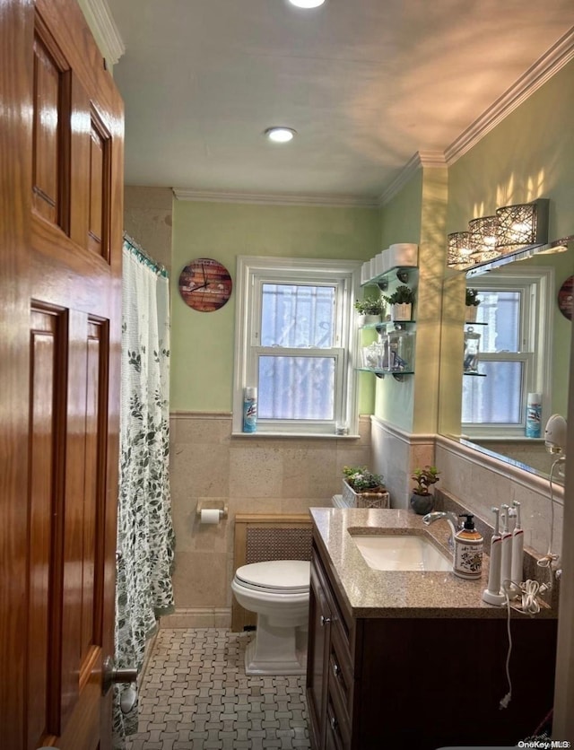 bathroom featuring ornamental molding, vanity, tile walls, tile patterned flooring, and toilet