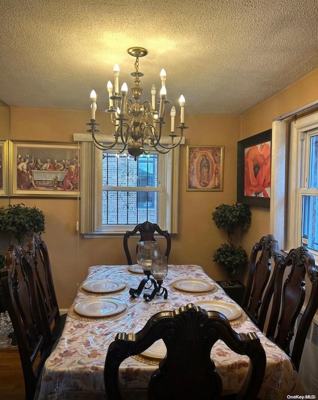 dining room featuring a textured ceiling and a notable chandelier