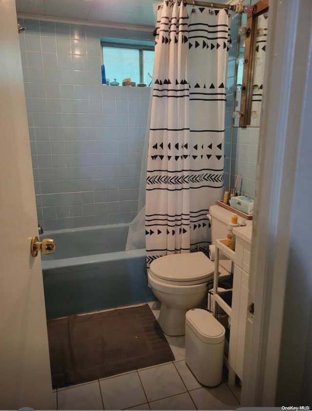 bathroom featuring tile patterned flooring, toilet, and shower / bath combo with shower curtain