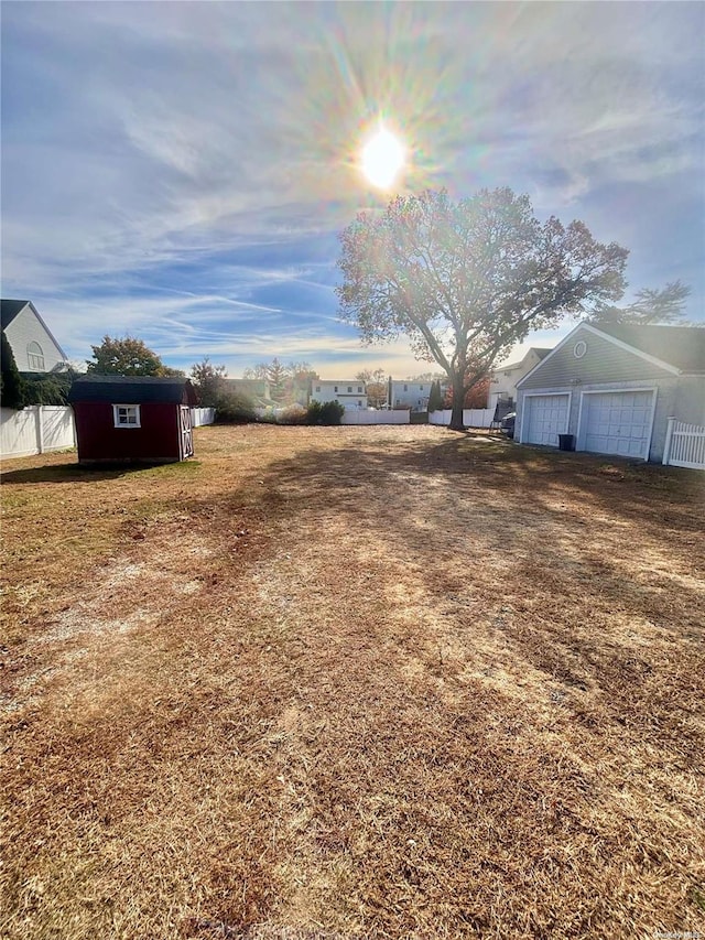 view of yard featuring an outbuilding and a garage