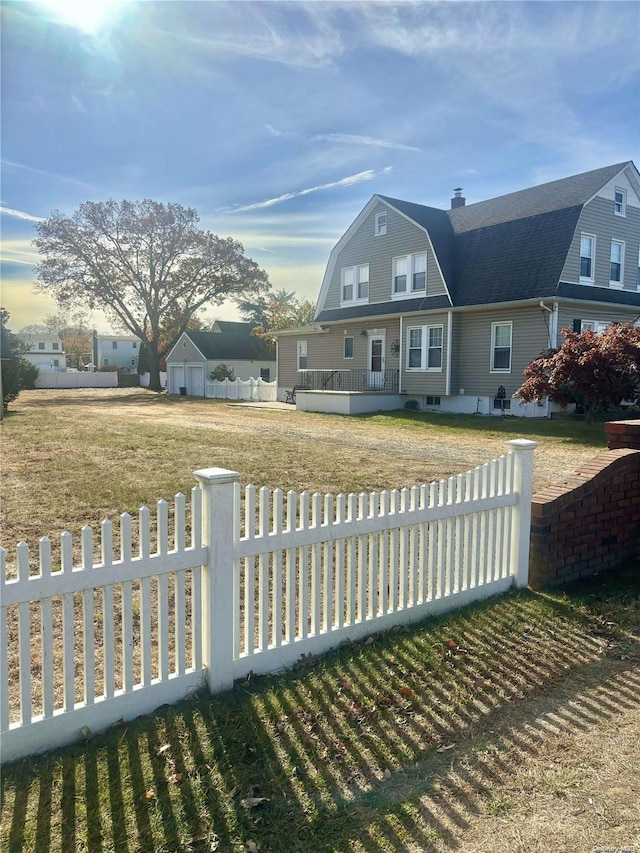 view of front of property with a front yard and a deck