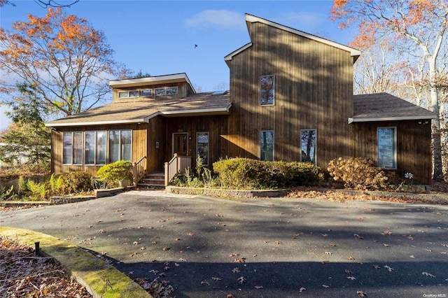 1572 Middle Rd, Calverton, NY 11933 - view of front of property with a sunroom and a shingled roof