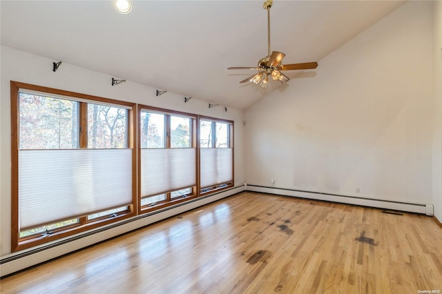 unfurnished room with ceiling fan, light hardwood / wood-style floors, a baseboard radiator, and vaulted ceiling