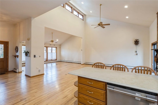 kitchen with ceiling fan, high vaulted ceiling, stainless steel dishwasher, and light wood-type flooring