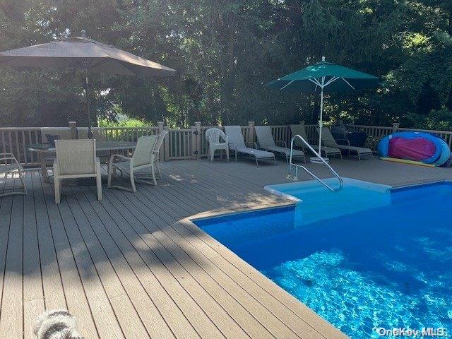 view of swimming pool with a wooden deck