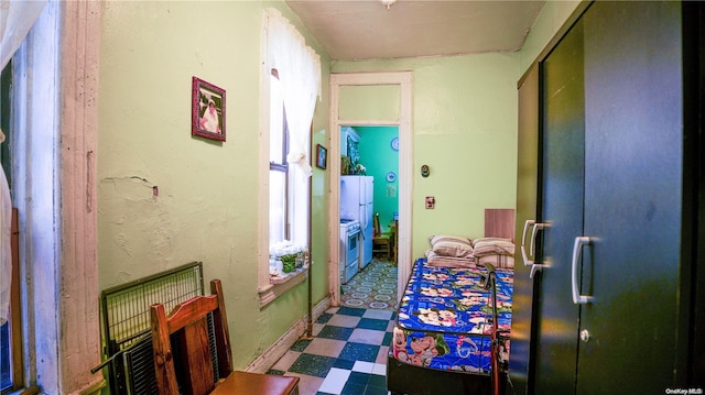 hallway with tile patterned floors