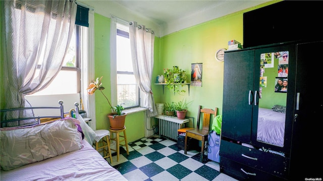 bedroom featuring tile patterned floors and radiator heating unit