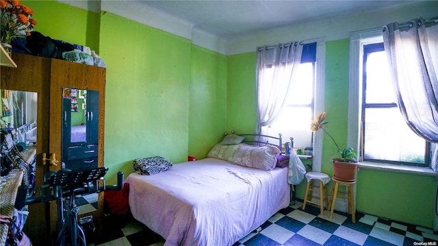 bedroom featuring tile patterned floors and multiple windows