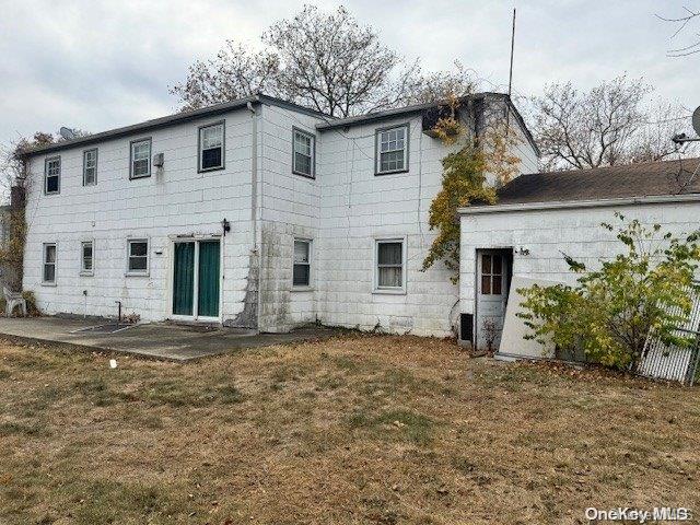 back of house with a yard and a patio area