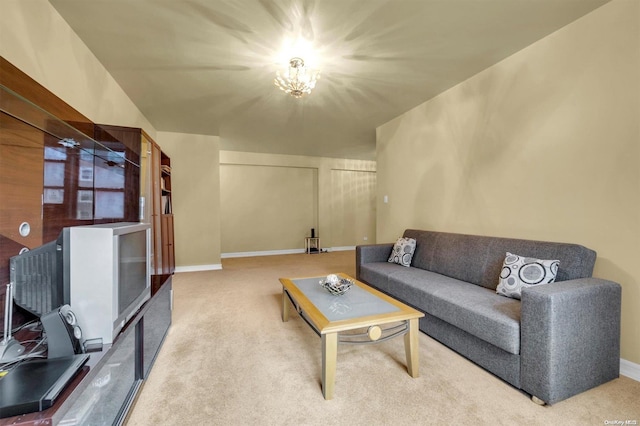 living room featuring carpet and a notable chandelier