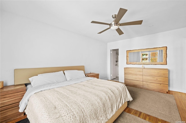 bedroom with ceiling fan and hardwood / wood-style flooring