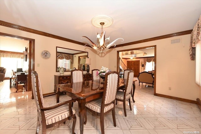 dining room with a notable chandelier and ornamental molding