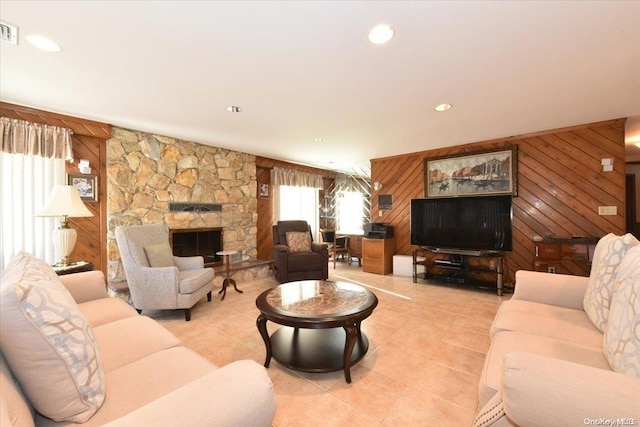 tiled living room with a fireplace and wooden walls