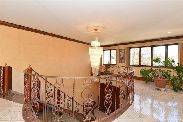 stairway with ornamental molding and an inviting chandelier