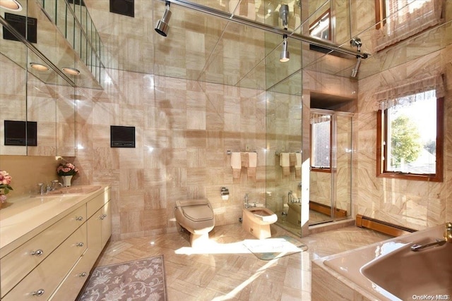 bathroom with vanity, a baseboard radiator, a bidet, tile walls, and toilet